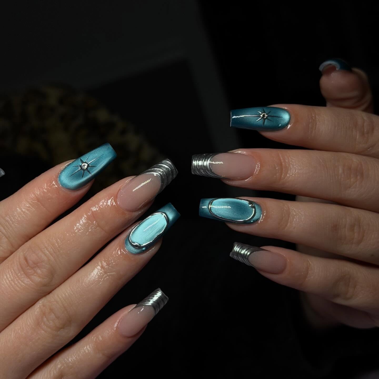 Teal chrome coffin nails with silver starburst art and mirrored French tips by Rita