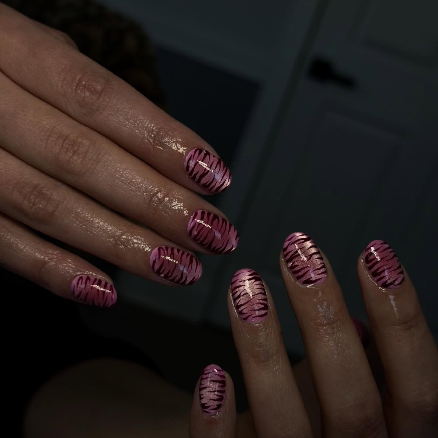 Rose-gold chrome short round nails with burgundy tiger stripe art by Rita