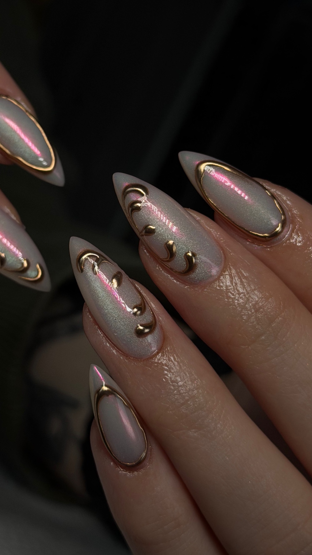 Pearlescent almond nails with gold 3D swirl accents by Rita