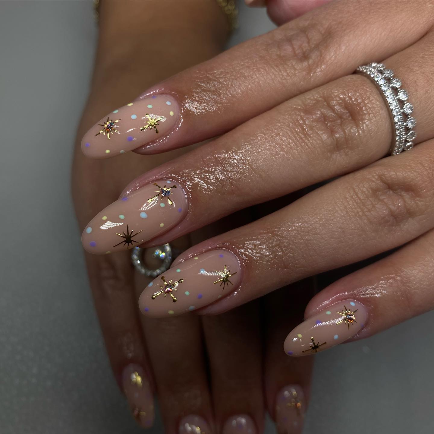 Nude nails with gold starbursts and pastel dot art by Rita